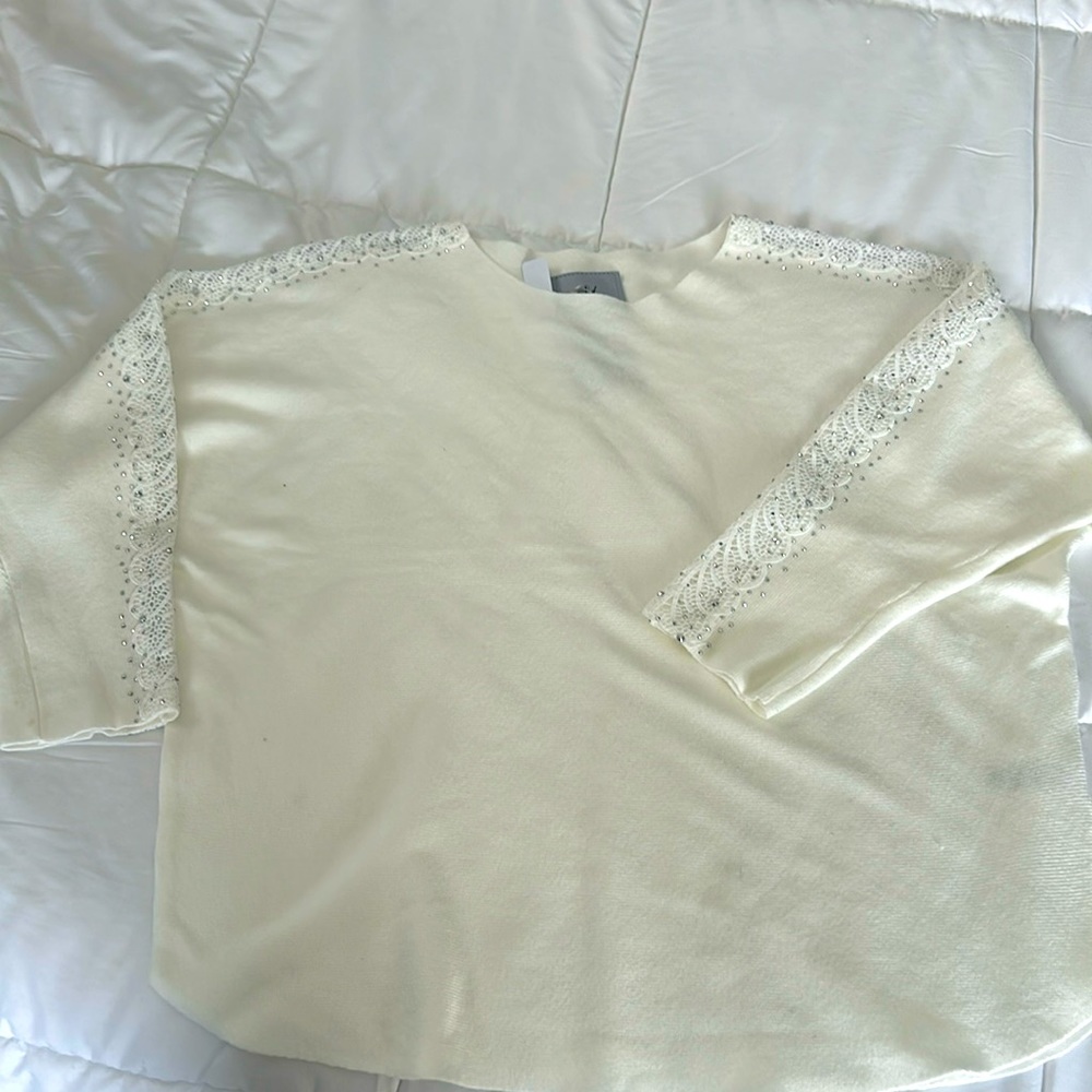 Brand new never worn top. Rhinestone lace detail on the sleeve- eggshell
